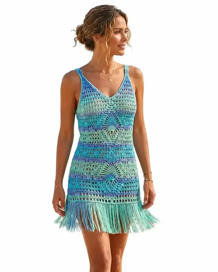 Woman wearing a blue and green openwork crochet dress with fringe