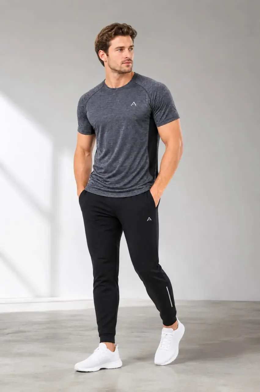 Man wearing a charcoal performance T-shirt and black activewear joggers